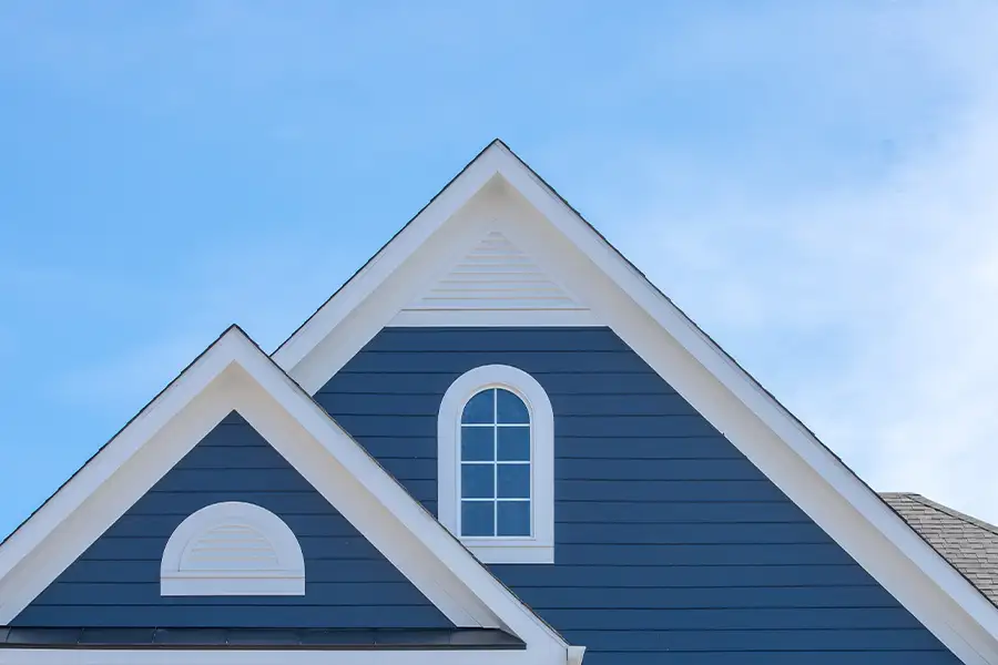 roofing contractors, focus on soffit and fascia of blue house - Madison County, Illinois