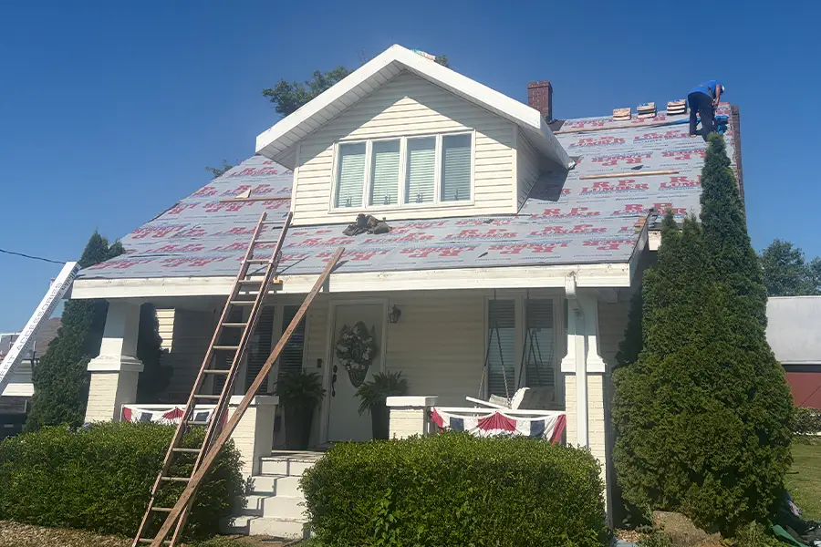 Roofing contractors, professional roofer working to lay out new tiles - Madison County, Illinois